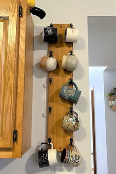 there are cups and mugs hanging on the wall