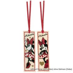 two cross stitch bookmarks with minnie and mickey mouses on them, hanging from red ribbon