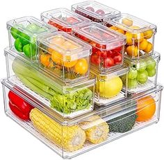 several plastic containers filled with different types of fruits and vegetables on top of each other