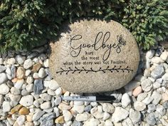 a rock that says good byes has been placed next to some rocks with writing on it