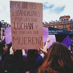 a group of people holding up signs in the air