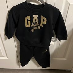 Brand New Baby Boy Gap Mickey Outfit With Tags Size 6-12 Months Retails $55 Adorable Black Sweatpants And Matching Sweatshirt With Gold Logo Cute Black Sets For Playtime, Casual Gap Playwear Sets, Cute Black Playwear Sets, Gap Casual Playwear Sets, Gap Sporty Fleece Sweatshirt, Sporty Hooded Gap Sweatshirt, Baby Gap Boy Outfits, Baby Gap Girl Outfits, Toddler Boy Sweat Suits