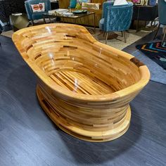 a large wooden bowl sitting on top of a hard wood floor