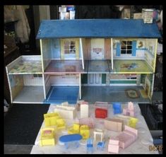 a doll house with furniture and accessories on display in a store or playroom area