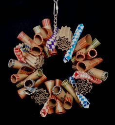 a bunch of different colored objects hanging from a metal chain on a black background,