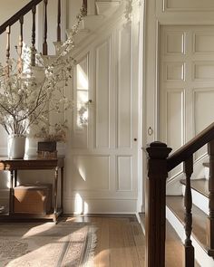 an elegant staircase with white flowers in a vase