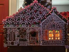 a gingerbread house is decorated with candy canes