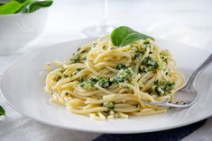 a white plate topped with pasta and broccoli