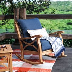 a rocking chair and table on a deck