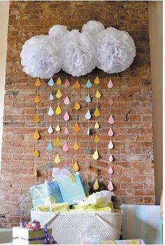 there is a brick wall with paper umbrellas hanging from it