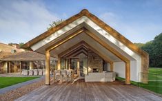 an outdoor living area with wooden decking and white furniture