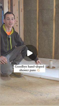 a man sitting on top of a floor next to a wall under construction with the caption goodbye hands - dropped shower pans