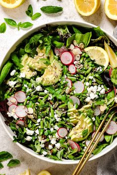 a salad with radishes, cucumbers and cheese in a white bowl