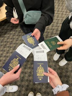 several people are holding their passport in the middle of a circle