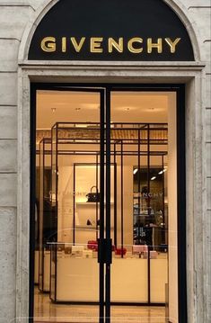 the entrance to a store with glass doors that say, givenchy on it