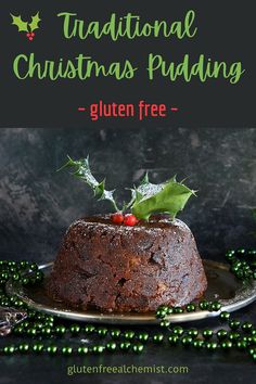 a christmas pudding on a plate with holly leaves and green beads around it, in front of a black background