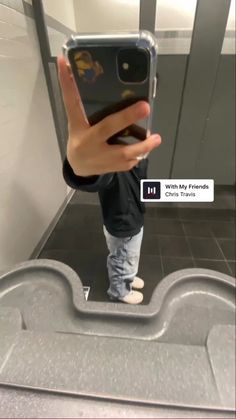 a person taking a selfie in front of a mirror with their cell phone up