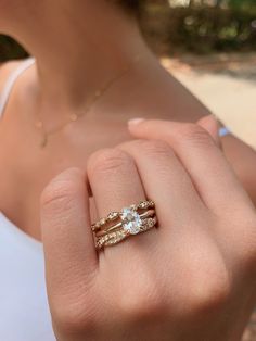 a woman's hand with two rings on it and one is holding the other