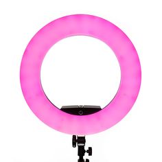 a pink ring light sitting on top of a tripod