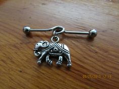 an elephant charm is sitting on a wooden table