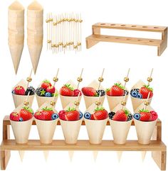 a bunch of strawberries and blueberries in cones on a wooden shelf with other items