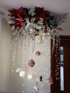 christmas decorations hanging from the ceiling with lights