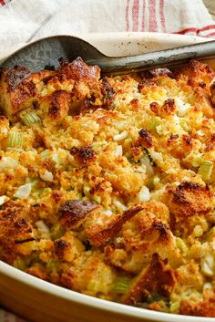 a casserole dish with stuffing and vegetables in it