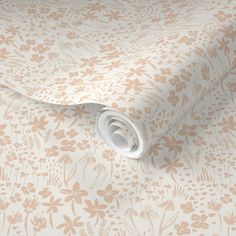 an image of a floral wallpaper with white and pink flowers on the background, as well as a roll of tape