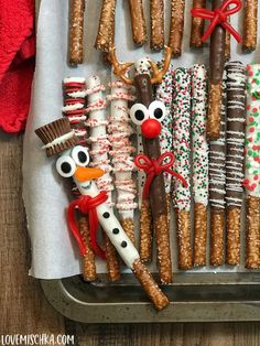 christmas pretzels and crackers are arranged in the shape of reindeers, snowmen, and santa's helpers