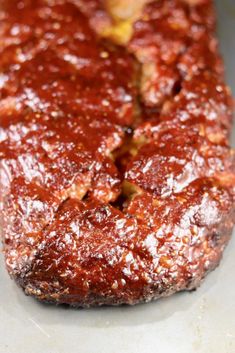 the meatloaf is covered with sauce and seasoning