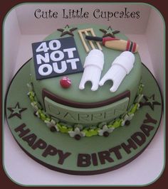 a birthday cake for a little boy with cricket equipment on it and the words happy birthday