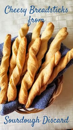 some bread sticks sitting on top of a blue and white towel with the words cheesy breadsticks from scarborough disard