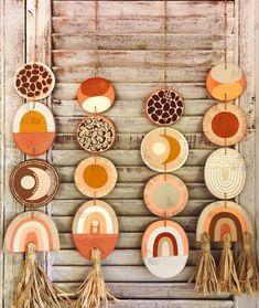 some plates are hanging on the wall with tassels and other decorations around them