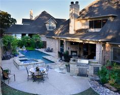 a backyard with a pool, grill and dining table next to an outdoor living area