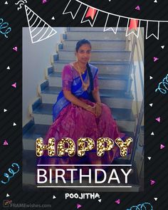 a woman sitting on top of a set of stairs wearing a blue and pink sari