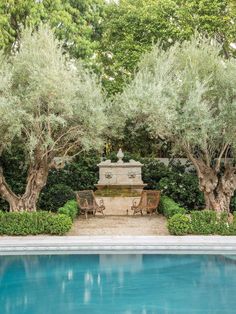 an empty pool surrounded by trees and benches