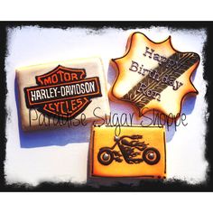 three decorated cookies with the words harley davidson and motorcycle logos on them are shown here