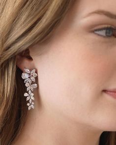 a close up of a person wearing earrings