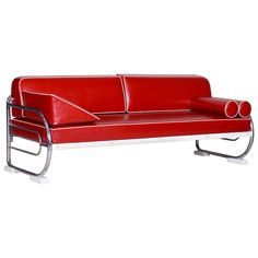 a red leather couch sitting on top of a metal frame