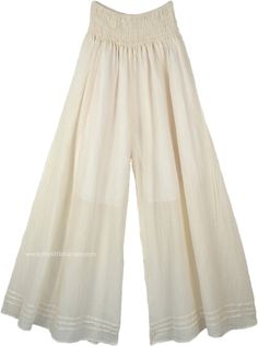 A pair of palazzo pants in ivory off white that you can wear in every season, these pants are extremely comfortable and are made of lightweight cotton fabric. The bottom of the pants is very wide, which gives it a flow and a feminine look as you walk. These pants have pin tuck details at the bottom near the hemline. Perfect for summer evenings out with friends, you can simply wear these casual wide-leg pants with a solid top of any color you like according to the occasion. Wear some jewelry to e White Harem Pants With Loosely Fitted Hips, Beige Cotton Full Length Wide Leg Pants, Beige Cotton Wide Leg Full Length Pants, Beige Cotton Wide Leg Full-length Pants, White Wide-leg Harem Pants With Elastic Waistband, Off White Cotton Wide Leg Pants For Spring, White Cotton Wide Leg Pants With Elastic Waistband, Spring Off White Cotton Wide Leg Pants, Beige Cotton Harem Pants For Summer