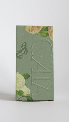 a green box with flowers and butterflies on it