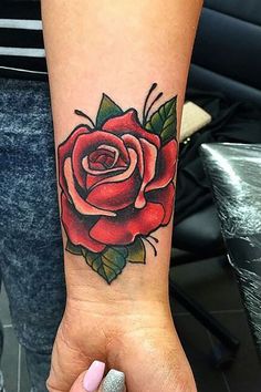 a woman's arm with a rose tattoo on it