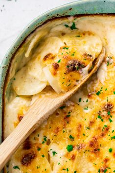 a casserole dish filled with cheese and meat