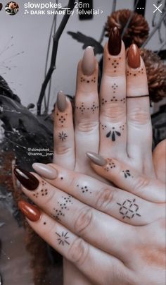 a woman's hand with some tattoos on it