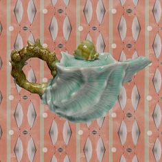 there is a sea shell with a fish in it on the pink wallpapers