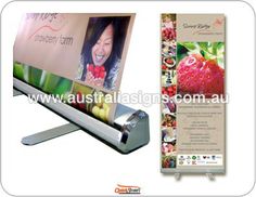 a roll up banner with an image of a strawberry on the front and back side