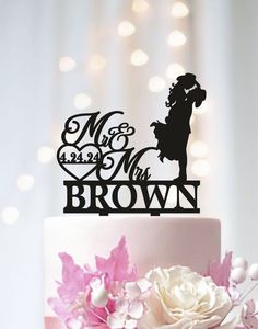 a wedding cake topper that says mr and mrs brown on it with pink flowers