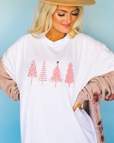 🎄 Pretty in Pink for the Holidays! 🌸 Elevate your Christmas style with our charming Pink Christmas Tree shirt. Perfect for adding a pop of festive elegance to your holiday wardrobe. ✨ Available now to make your season merry and bright. 💖👕 Christmas Pink Cotton Tops, Pink Cotton Christmas Tops, Cute Winter Holiday T-shirt, Cute Holiday T-shirt For Winter, Holiday Winter Graphic Tee, White Relaxed Fit Christmas T-shirt, Cute Long Sleeve T-shirt For Holiday, White Relaxed Fit T-shirt For Christmas, Relaxed Fit Long Sleeve Holiday T-shirt