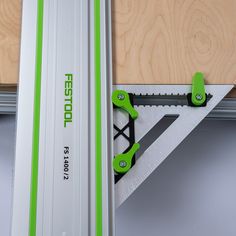 a pair of green and white skis hanging on a wall