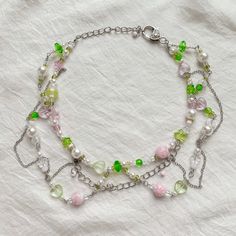 "Statement necklace made from beads and chains in forest style. Pastel green and pink colors are combined with stainless steel. Perfect for those who love unusual and unique jewelry. ♡IMPORTANT: - Listing is for 1 necklace - Video without filters  - Pink round beads will be replaced with glitter glass beads (sixth photo)  ♡SIZE: - This necklace is made in 16.9\" length or 43 centimeters (adjustable) - The size of the choker is standard, but if you need a specific size, write it in the notes to the order or in a message. ♡GIFT - Gift for buying 2 or more items in our store ♡SHIPPING - I am sending from Bulgaria - We ship all orders with a track number and do expedited shipping, but due to the pandemic, orders delivery may still take longer time - Your item will be dispatched within 3 workin Pastel Green And Pink, Aesthetic Kidcore, Forest Style, Green Beaded Necklace, Green Star, Pink Round, 2000s Aesthetic, Glitter Glass, May 2023